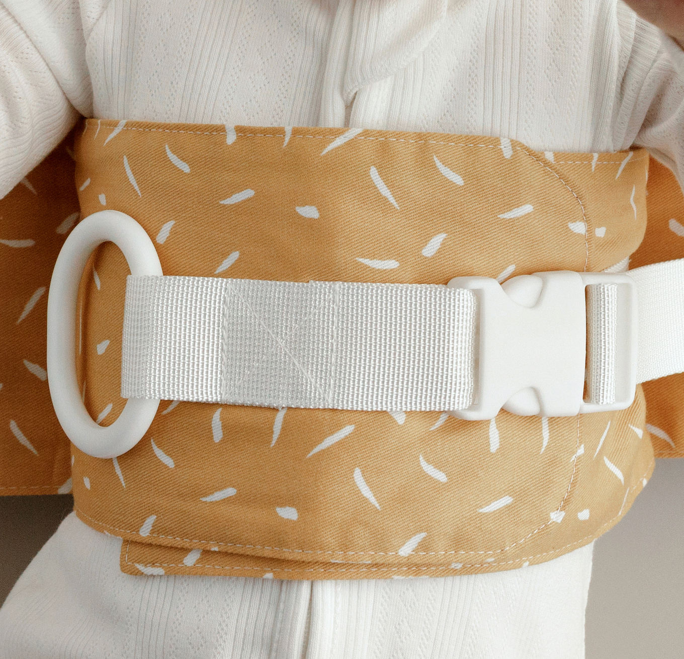 Close up of a Butterscotch Sprinkle WriggleBum nappy change harness. 