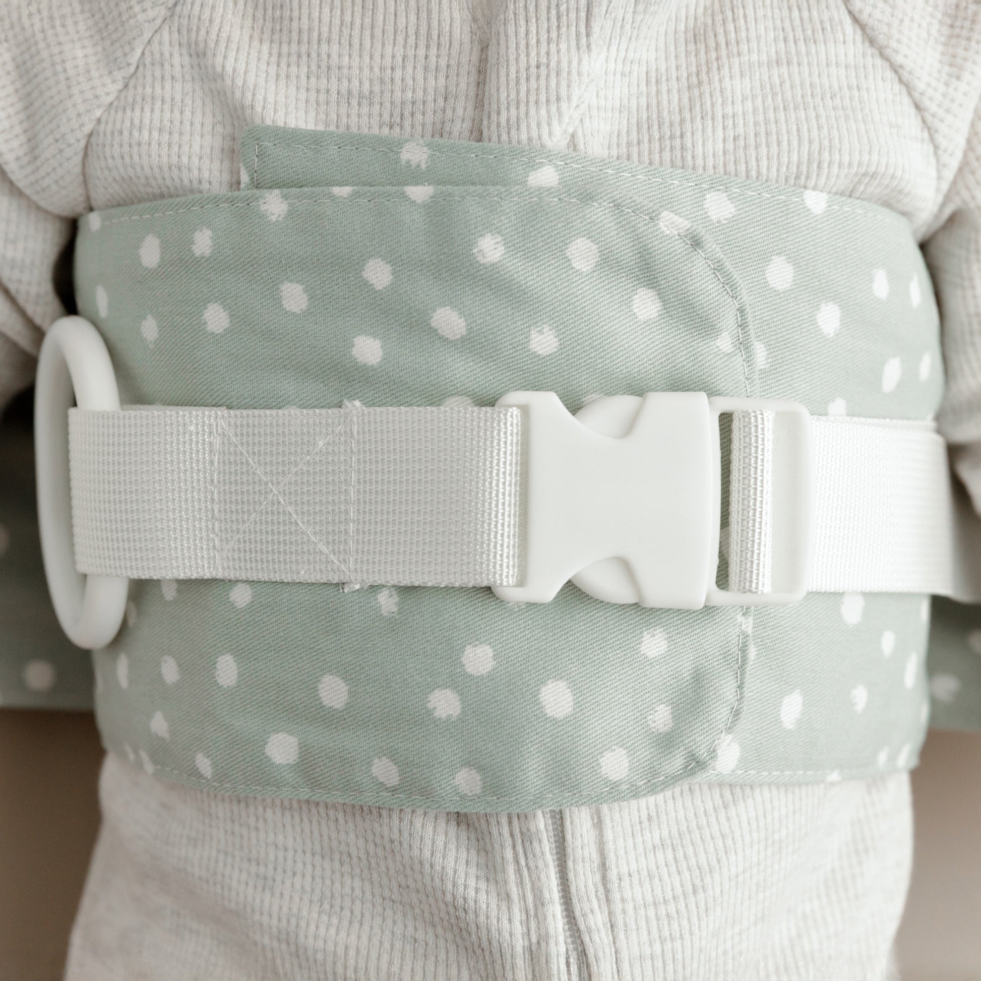 A close-up of the Sage Whimsy WriggleBum nappy change harness. 